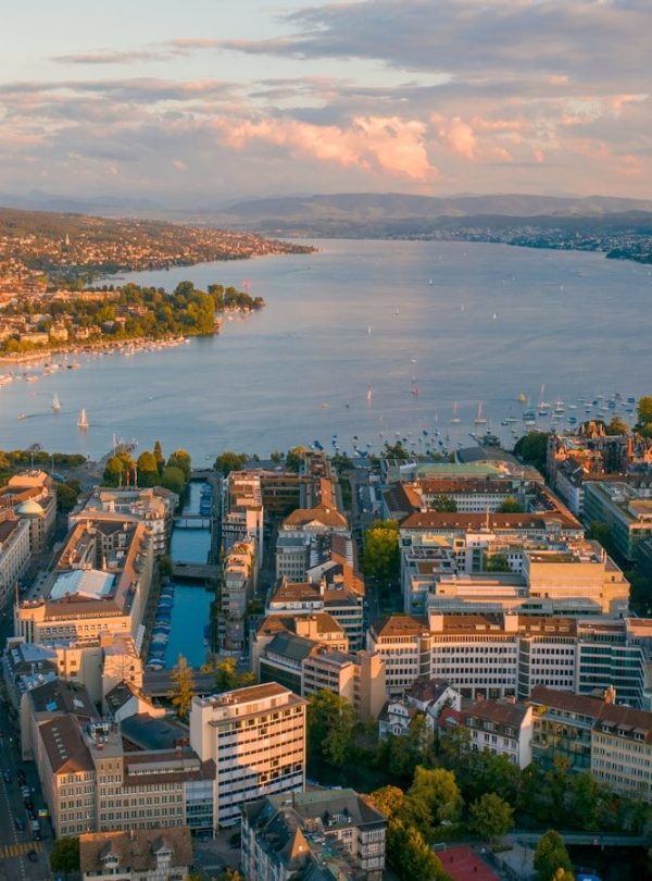 aerial view of city buildings near body of water during daytime